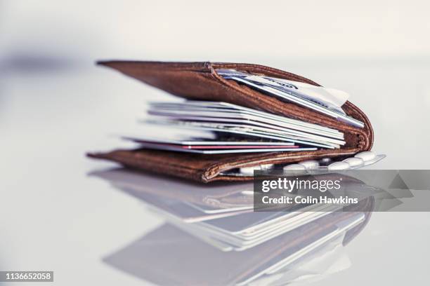 fat wallet with numerous credit cards - wallet stock-fotos und bilder