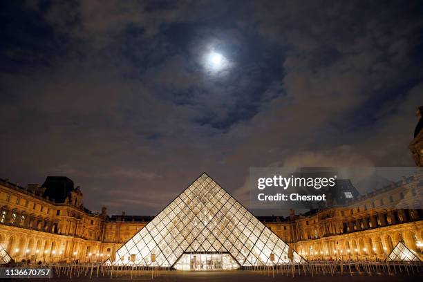 The Louvre Pyramid and the Louvre museum are seen at night on March 18, 2019 in Paris, France. The pyramid of the Louvre Museum celebrates its 30th...