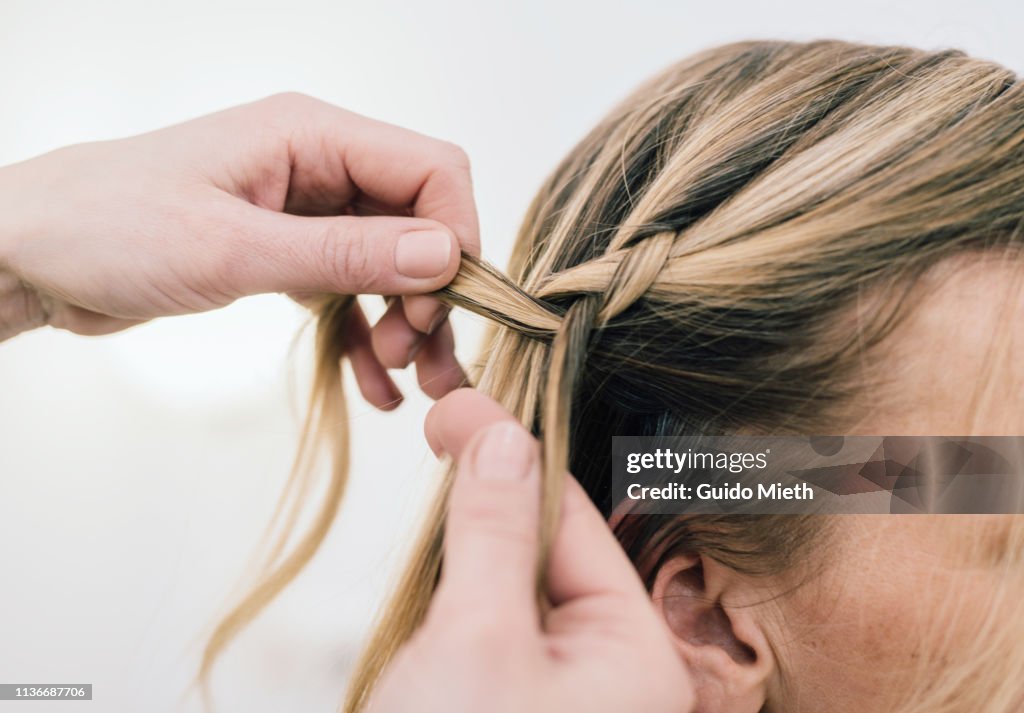 Make-up artist doing hair.