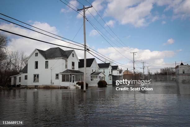 Homes are surrounded by floodwater from the Pecatonica River on March 18, 2019 in Freeport, Illinois. Several Midwest states are battling some of the...