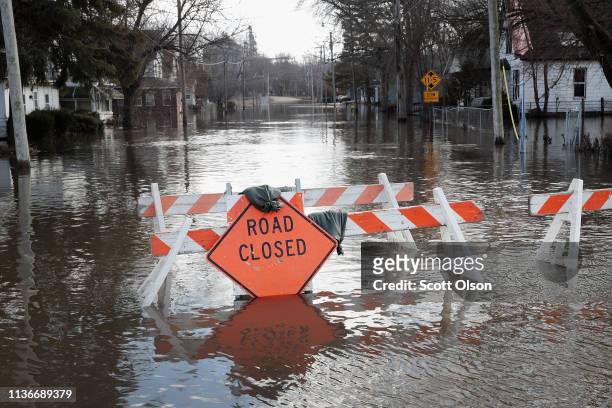 Road is covered with floodwater from the Pecatonica River on March 18, 2019 in Freeport, Illinois. Several Midwest states are battling some of the...