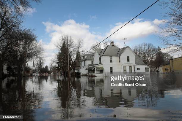 Homes are surrounded by floodwater from the Pecatonica River on March 18, 2019 in Freeport, Illinois. Several Midwest states are battling some of the...