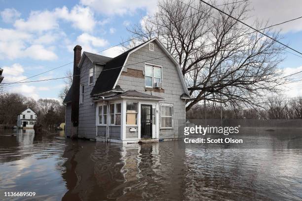 Home is surrounded by floodwater from the Pecatonica River on March 18, 2019 in Freeport, Illinois. Several Midwest states are battling some of the...