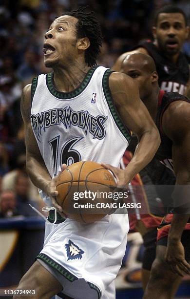 Minnesota Timberwolves' Troy Hudson drives past the Miami Heat defense for a layup in the third quarter of their NBA game 25 March at the Target...