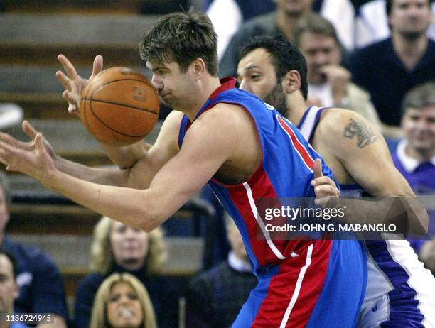 Detroit Pistons' center Mehmet Okur gets his nose into the ball as Sacramento Kings' center Vlade Divac defends during the fourth period of their...