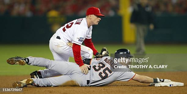 San Francisco Giants' Rich Aurilia hangs on to second base after hitting a double as Anaheim Angels' short stop David Eckstein is late with the tag...