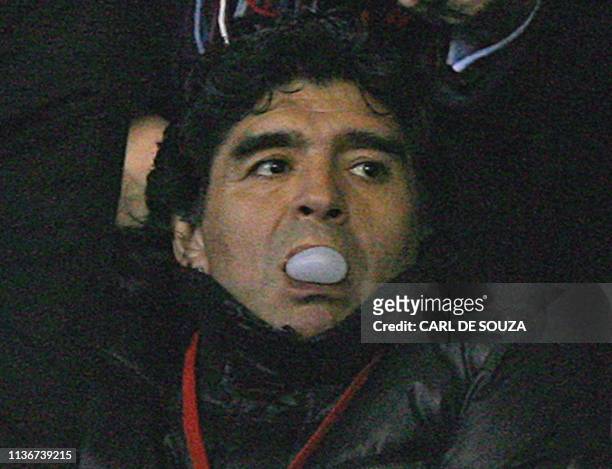 Argentina's football coach Diego Maradona blows a bubble with gum before the Premiership match between Stoke City and Liverpool at home to Stoke...