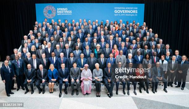 In this handout photo provided by the IMF, Bank Governors and Finance Ministers pose for the International Monetary Fund's Governors official...