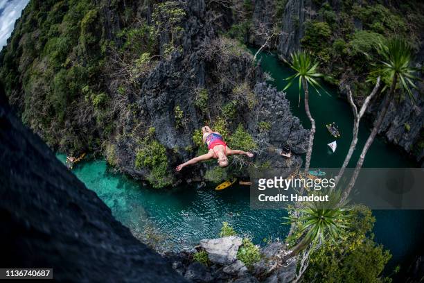 In this handout image provided by Red Bull, Rhiannan Iffland of Australia dives from a rock pinnacle at the Small Lagoon on Miniloc Island during the...