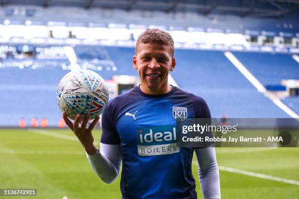 Dwight Gayle of West Bromwich Albion with the signed match ball at full time after his hat trick during the Sky Bet Championship match between West...