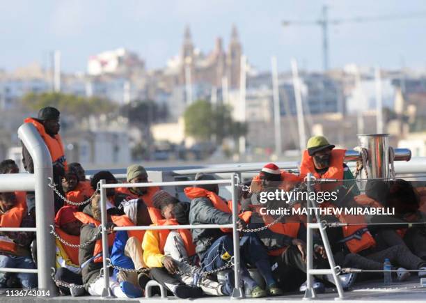 Migrants who were stuck on a ship since their rescue in the Mediterranean 10 days ago, arrive to disembark in Valletta, Malta on April 13, 2019 after...