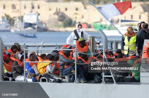 Some of the migrants who were stuck on a ship since their rescue in the Mediterranean 10 days ago, arrive to disembark in Valletta, Malta on April...