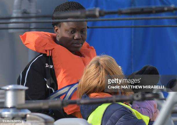 Woman and a child with the migrants who were stuck on a ship since their rescue in the Mediterranean 10 days ago, are being welcomed after...