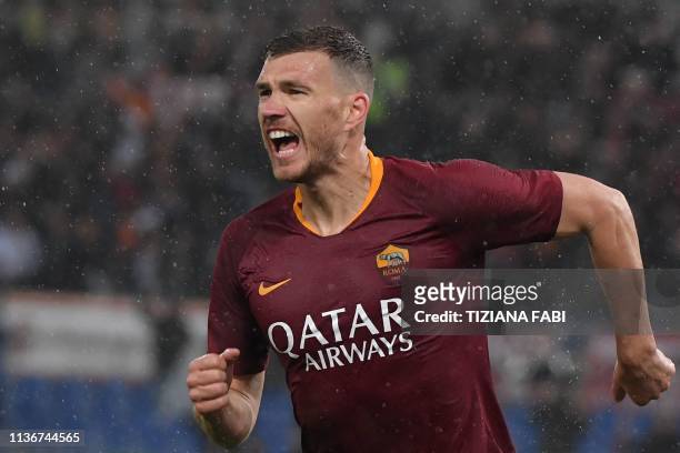 Roma Bosnian forward Edin Dzeko celebrates after opening the scoring during the Italian Serie A football match AS Roma vs Udinese on April 13, 2019...