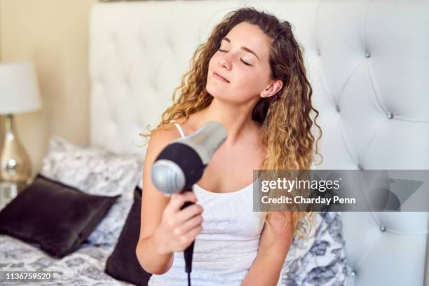 she puts extra care into her hair - blow drying hair stock pictures, royalty-free photos & images