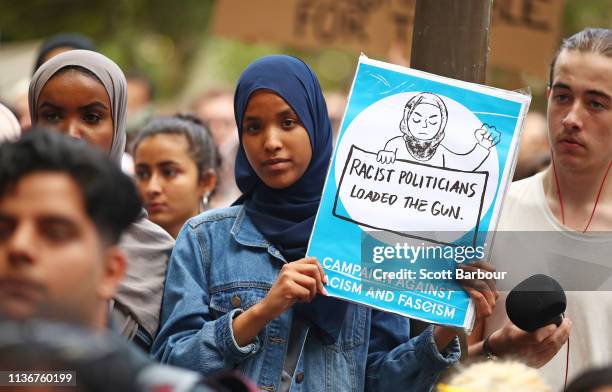 Protesters hold placards aloft as they march during the Stand Against Racism and Islamophobia: Fraser Anning Resign! rally on March 19, 2019 in...