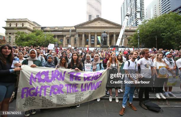 Protesters hold placards aloft as they march during the Stand Against Racism and Islamophobia: Fraser Anning Resign! rally on March 19, 2019 in...