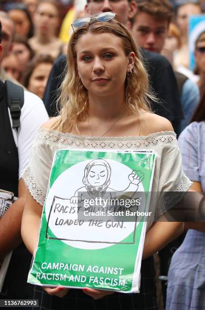 Protesters hold placards aloft as they march during the Stand Against Racism and Islamophobia: Fraser Anning Resign! rally on March 19, 2019 in...