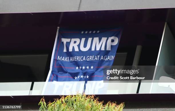 Trump: Make America Great sign hangs from a window in a building above the Stand Against Racism and Islamophobia: Fraser Anning Resign! rally on...