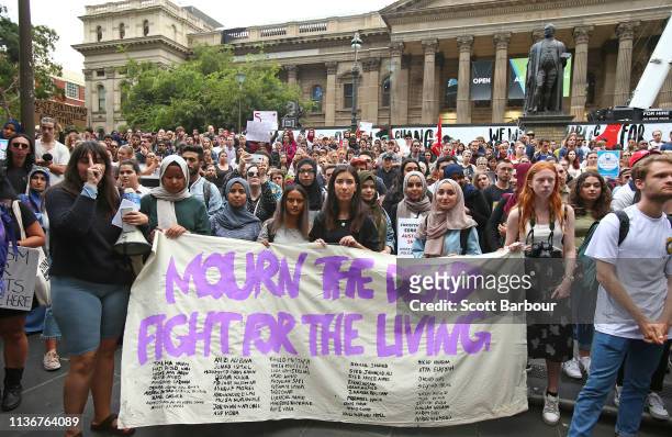 Protesters hold placards aloft as they march during the Stand Against Racism and Islamophobia: Fraser Anning Resign! rally on March 19, 2019 in...