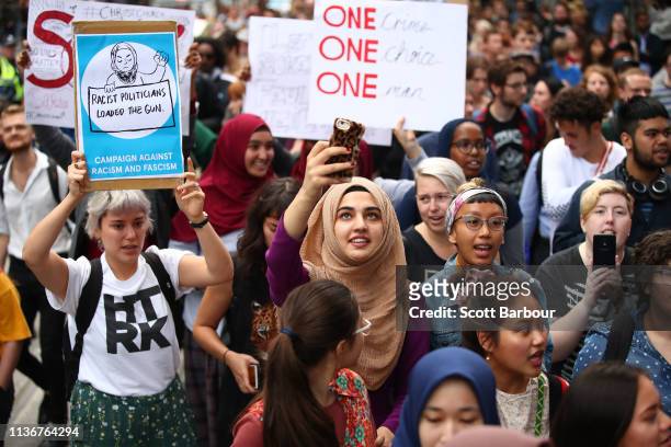 Protesters hold placards aloft as they march during the Stand Against Racism and Islamophobia: Fraser Anning Resign! rally on March 19, 2019 in...