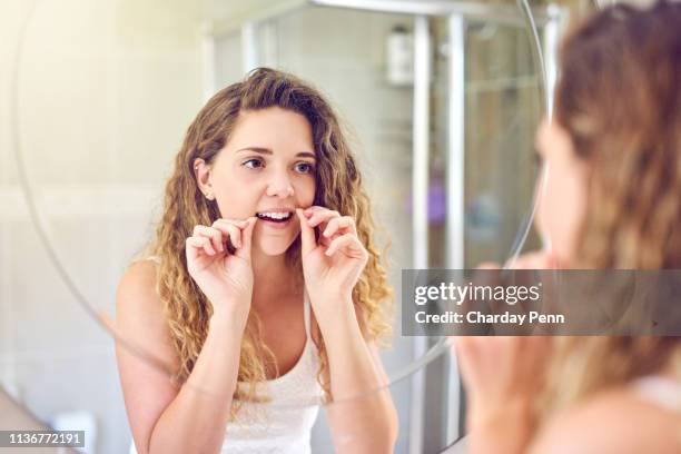 got to keep those pearly white clean all around - dental floss stock pictures, royalty-free photos & images