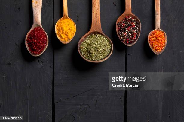 spices and herbs with old wooden spoons on wooden background - mint leaf restaurant stock pictures, royalty-free photos & images
