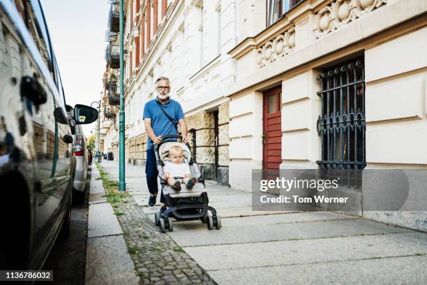 grandfather out for the day with grandson - stroller stock pictures, royalty-free photos & images