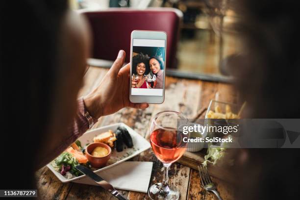 selfies at dinner - call to arms stock pictures, royalty-free photos & images