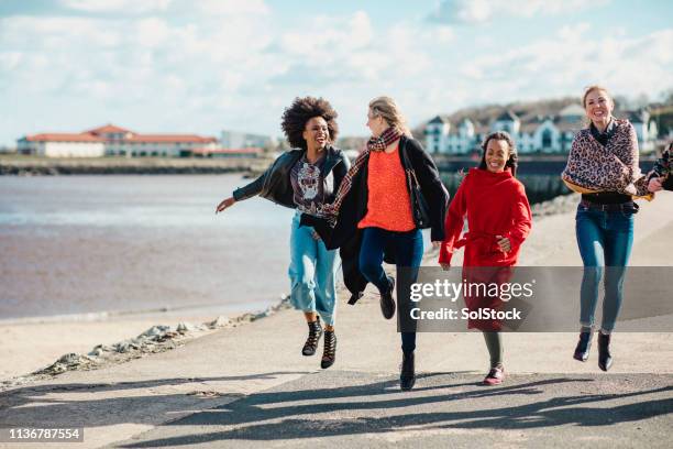 friends jumping for joy - north shields 個照片及圖片檔