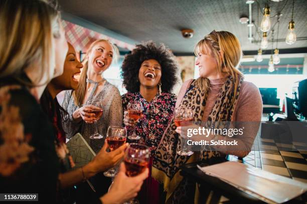 friends enjoying wine - girls night out stockfoto's en -beelden