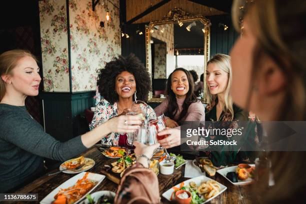 cheers! - friends in restaurant bar stockfoto's en -beelden