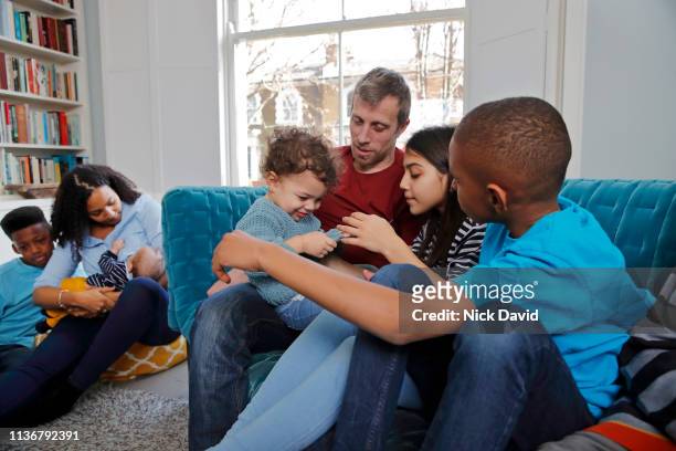 Multi ethnic family relaxing in living room