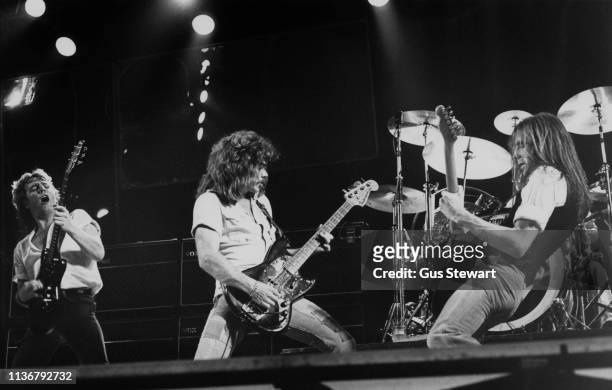 Rick Parfitt, Alan Lancaster and Francis Rossi of Status Quo perform on stage circa 1978.