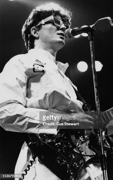 Mark Mothersbaugh of Devo performs on stage circa 1978. He is playing a Gibson Explorer guitar with effects pedals taped to it.