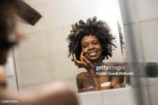 woman applying face cream - face cream stock pictures, royalty-free photos & images