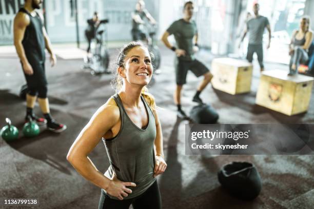 happy athletic woman taking a break from cross training in a gym. - circuit training stock pictures, royalty-free photos & images