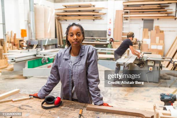 portrait of young black female worker in a furniture factory - black business owner ストックフォトと画像