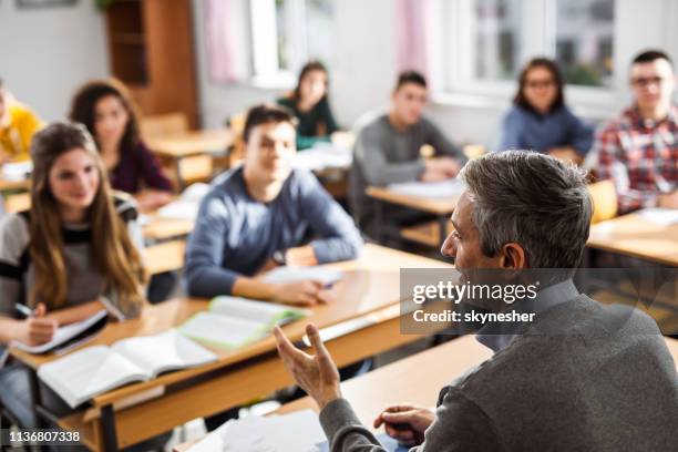 Professor Instructing Profile View Of A Professor Teaching A Lecture At High School High-Res ...