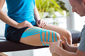 Kinesio taping on woman's knee