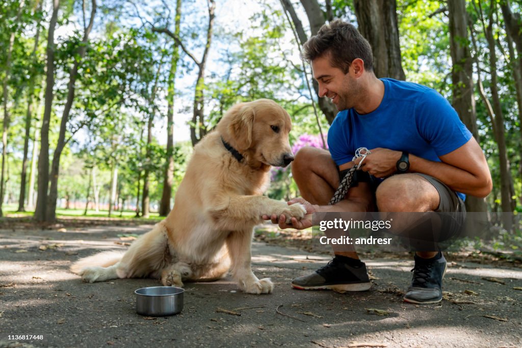 Happy man training with his dog at the park