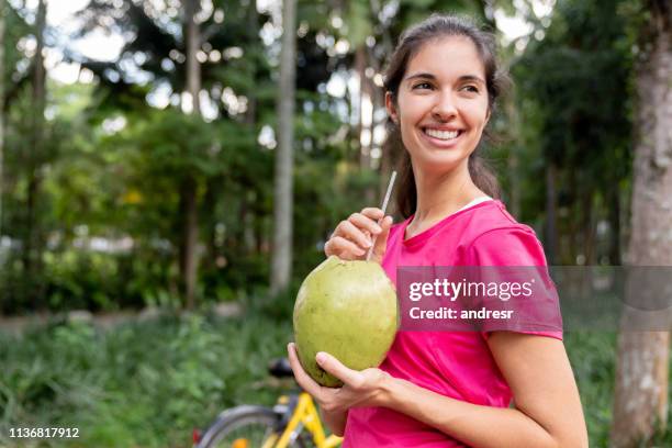 愉快的巴西婦女喝椰子水訓練後 - coconut water 個照片及圖片檔