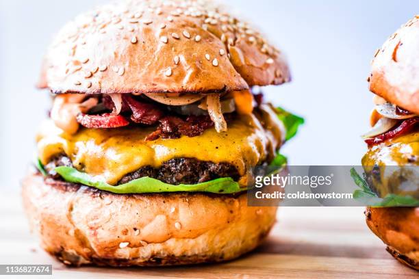 freshly flame grilled bacon cheese burgers in a row - pattie sellers stock pictures, royalty-free photos & images