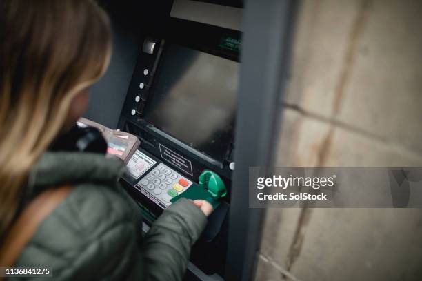 using a cash point - silver purse stock pictures, royalty-free photos & images