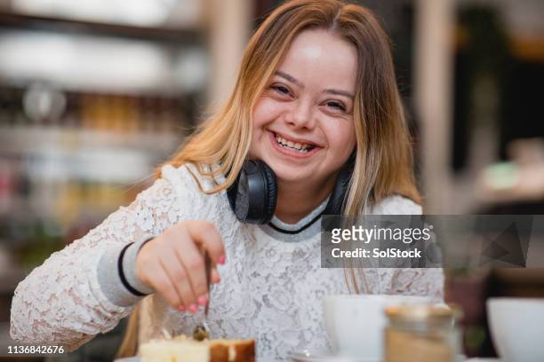 headshot of a happy young woman - disabilitycollection stock pictures, royalty-free photos & images