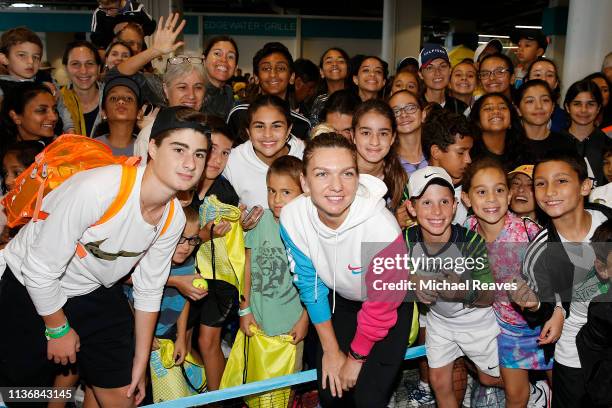 Simona Halep of Romania poses for a photo with young fans during the Kids Day event at the Miami Open Presented by Itau on March 19, 2019 in Miami...