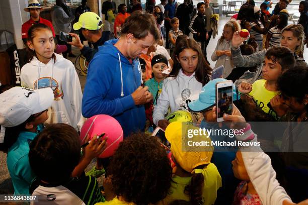 John Millman of Australia signs autographs for young fans during the Kids Day event at the Miami Open Presented by Itau on March 19, 2019 in Miami...