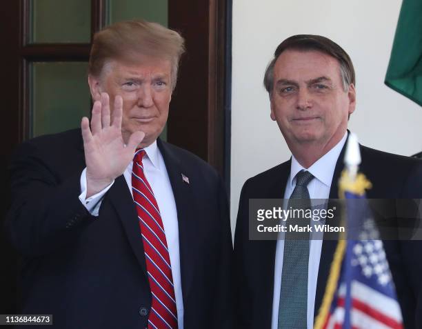 President Donald Trump greets Brazilian President Jair Bolsonaro upon his arrival at the West Wing of the White House March 19, 2019 in Washington,...