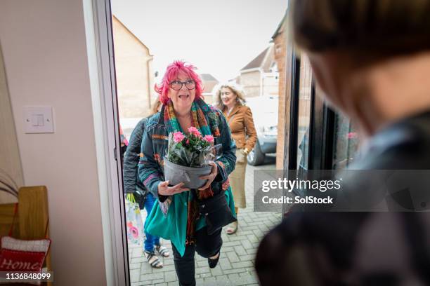 friends arriving for a dinner party - returning package stock pictures, royalty-free photos & images