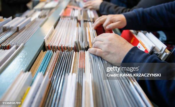 Customers shop for special edition vinyl records at Dusty Groove music store during the Record Store Day in Chicago on April 13, 2019. - Record Store...